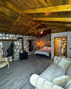 a living room with a bed and a fireplace at Çameli doğa hotel in Belevi