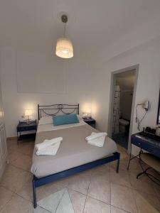 a bedroom with a large bed with two night stands at Rooms By Lignou in Fira
