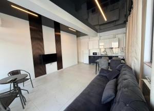 a living room with a large couch and a table at Apartament Poseidon in Mamaia Sat/Năvodari