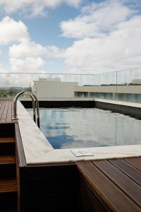a swimming pool on top of a building at Oporto Fly Hotel in Maia
