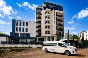 a white van parked in front of a building at Jalo Hotel - Shashemene in Shashemenē