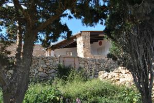 a stone house with a stone wall at Villetta Girasole in Lampedusa