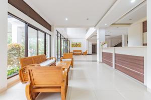 a corridor of a hospital with chairs and windows at Urbanview Hotel Tridaya Cisarua Puncak in Kopo 2