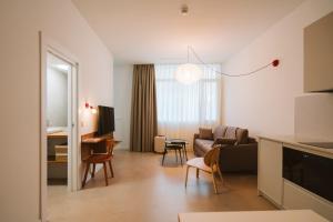a living room with a couch and a table at Apartamentos Turísticos - ELBUZONROJO in Burgos