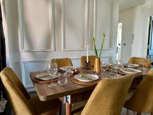 a dining room table with chairs and a candle on it at Penthouse Meknes in Meknès