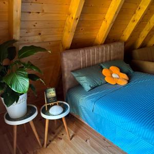 a bedroom with a bed with a plant and two tables at Careva staza in Nikšić