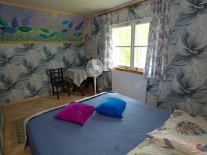 a bedroom with a bed with two pillows on it at Türi Puhkemaja - Murunella in Türi