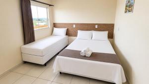 a small room with two beds and a window at Hotel Goedert in Major Vieira
