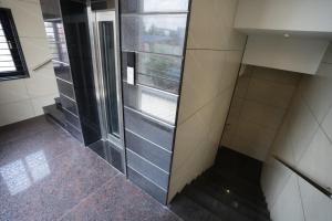 a walk in shower in a bathroom with a window at KAR Towers in Ārani