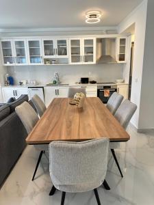 a kitchen and dining room with a wooden table and chairs at Nōema Residences II in Nafpaktos