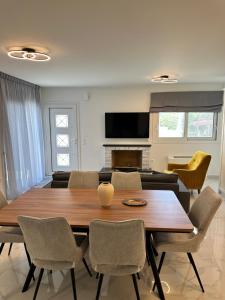 a living room with a wooden table and chairs at Nōema Residences II in Nafpaktos