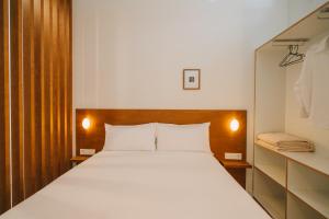 a bedroom with a large bed and a closet at Apartamentos Turísticos - ELBUZONROJO in Burgos