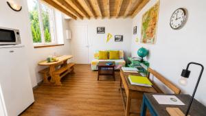 a living room with a couch and a table at L'école buissonnière chambres et table d'hôtes in La Celle-Dunoise