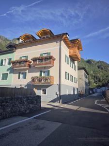 a building with balconies on the side of it at Il Laricino in Predazzo