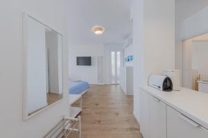 a white room with a bed and a white counter top at HOMESTWENTY3 - Home seven - Renovated in 2026 in Caorle