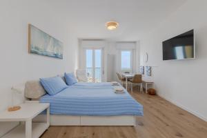 a white bedroom with a bed and a table at HOMESTWENTY3 - Home seven - Renovated in 2026 in Caorle +22 photos