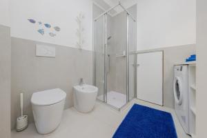 a white bathroom with a toilet and a shower at HOMESTWENTY3 - Home seven - Renovated in 2026 in Caorle