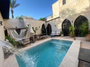 a swimming pool in the backyard of a house at Villa Bouchra in Marrakesh