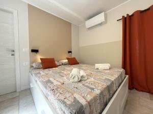 a bedroom with a large bed with shoes on it at Cozy House in Corte in Vimodrone