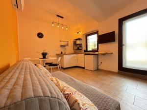 a bedroom with a bed and a table and a kitchen at Cozy House in Corte in Vimodrone
