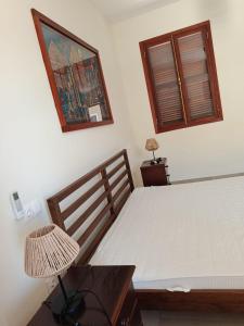a bedroom with a bed and a table and a mirror at Casa de los Encantos in Vila do Porto