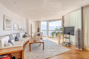 a living room with a white couch and a tv at Turm Chalet in Laces