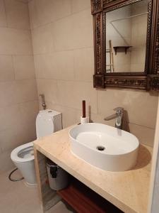 a bathroom with a sink and a toilet at Casa de los Encantos in Vila do Porto +7 photos