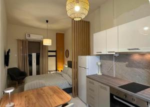 a kitchen with a table and a room with a bed at Jasmine Studio 3 Pigadia Siatista in Siátista +6 photos