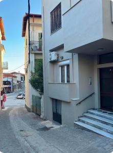 a building with stairs on the side of a street at Jasmine Studio 3 Pigadia Siatista in Siátista