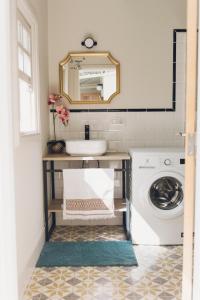 a bathroom with a sink and a washing machine at Casa Kilig 40 in Santa Cruz de Tenerife +82 photos