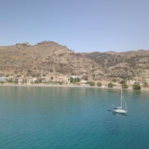 a boat in the middle of a large body of water at Triton Sea View Studios in Tsoutsouros