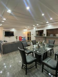 a living room with a table and chairs and a couch at AMINA luxury SUITE in Lomé
