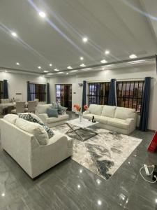 a large living room with couches and a table at AMINA luxury SUITE in Lomé