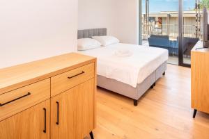 a bedroom with a bed and a large window at The Penthouse Bardolino in Bardolino +23 photos