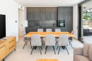 a dining room with a wooden table and chairs at The Penthouse Bardolino in Bardolino