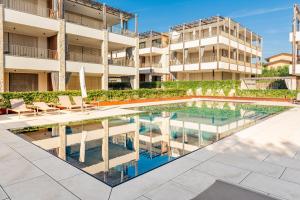 an image of a swimming pool in front of a building at The Penthouse Bardolino in Bardolino