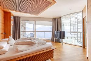 a bedroom with a large bed and a large window at Turm Chalet in Laces +43 photos