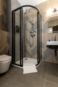 a bathroom with a shower and a toilet and a sink at Szauter Aparthomes A in Győr +39 photos