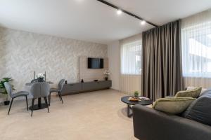 a living room with a couch and a table at Szauter Aparthomes A in Győr