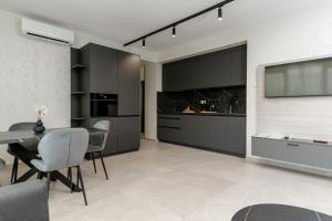 a living room with a table and a tv at Szauter Aparthomes A in Győr