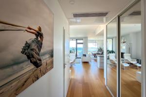 a living room with a painting of a woman on the wall at Panorama Suite in Hanko in Hanko