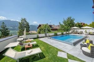 an image of a backyard with a swimming pool at Hotel Tyrol Plose in Bressanone