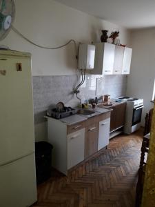 a kitchen with white cabinets and a sink in it at Petrovic in Sombor +13 photos