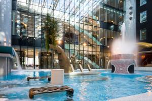 a large building with a fountain in front of it at Tallink Express Hotel in Tallinn