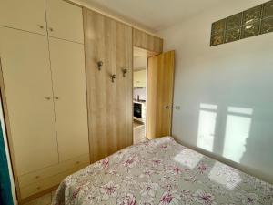 a bedroom with a bed and a closet at Rosmarino Apartment in Seccheto