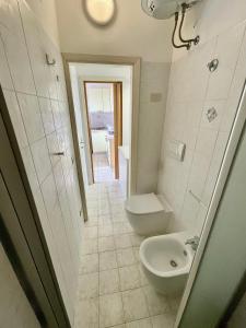 a bathroom with a toilet and a sink at Rosmarino Apartment in Seccheto