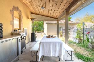 an outdoor kitchen with a table and a counter at Chambres D'hotes Le Cocon De Lily in Saint-Avit