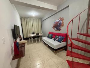 a living room with a couch and a television at Apes Raizes Douradas in Campinas