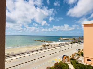 a view of the beach from the balcony of a condo at Demetra Seafront Apartment - Parking & Pool in Castel Volturno
