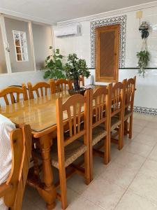 a dining room with a wooden table and chairs at Casa Perico Reyes in Cartagena